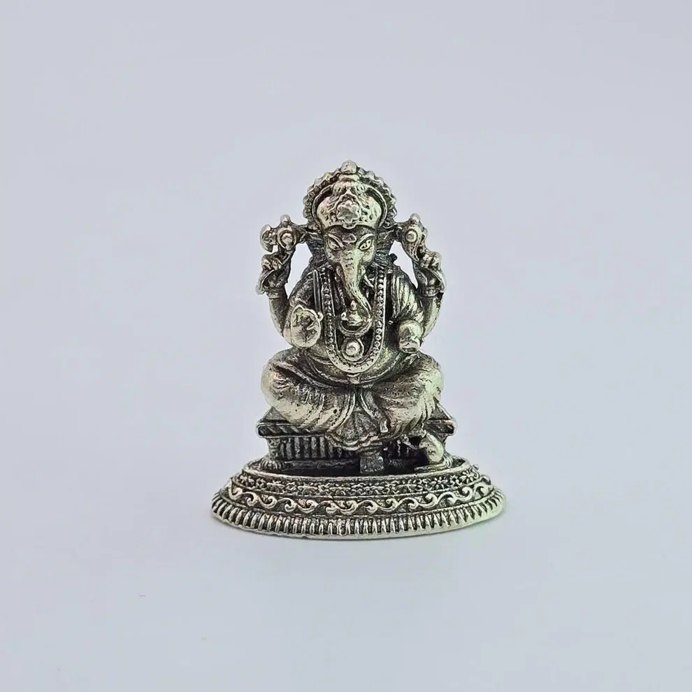 Height 1" approx  Pure silver Lord Ganesha idol featuring intricate antique-style craftsmanship. An auspicious and powerful gift for newlyweds, housewarmings, and office desks. High-quality silver puja article for home mandirs in Canada and USA. Handcrafted spiritual protection.